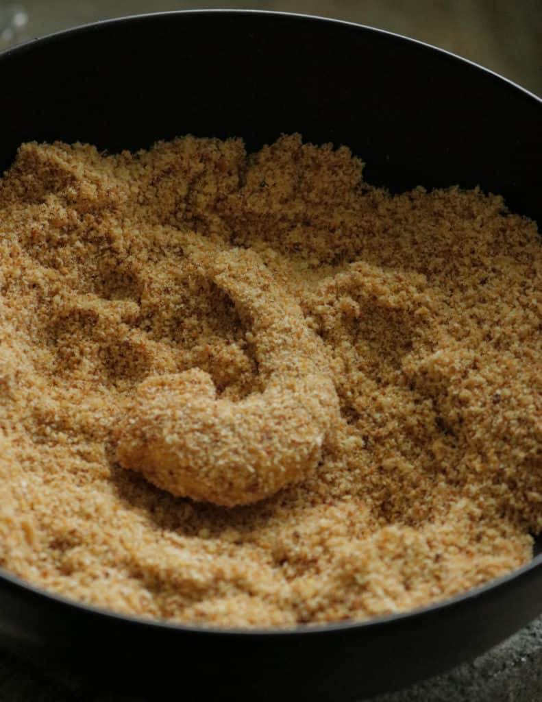 the shrimp completely covered in bread crumbs to make the crispy fried shrimp.