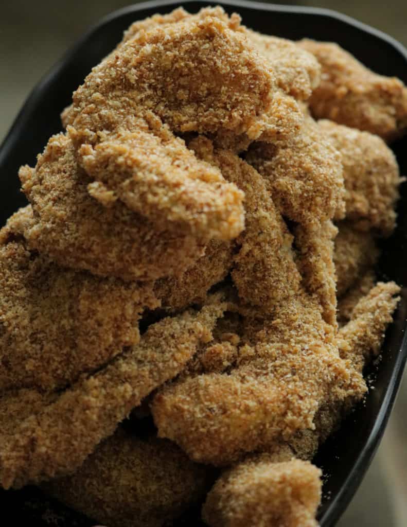 shrimp coated in seasoned flour, egg washed and then coated in bread crumbs ready to be fried..