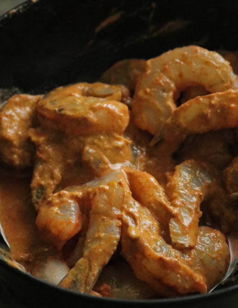 adding the shrimp to the tandoori paste and marinating it.