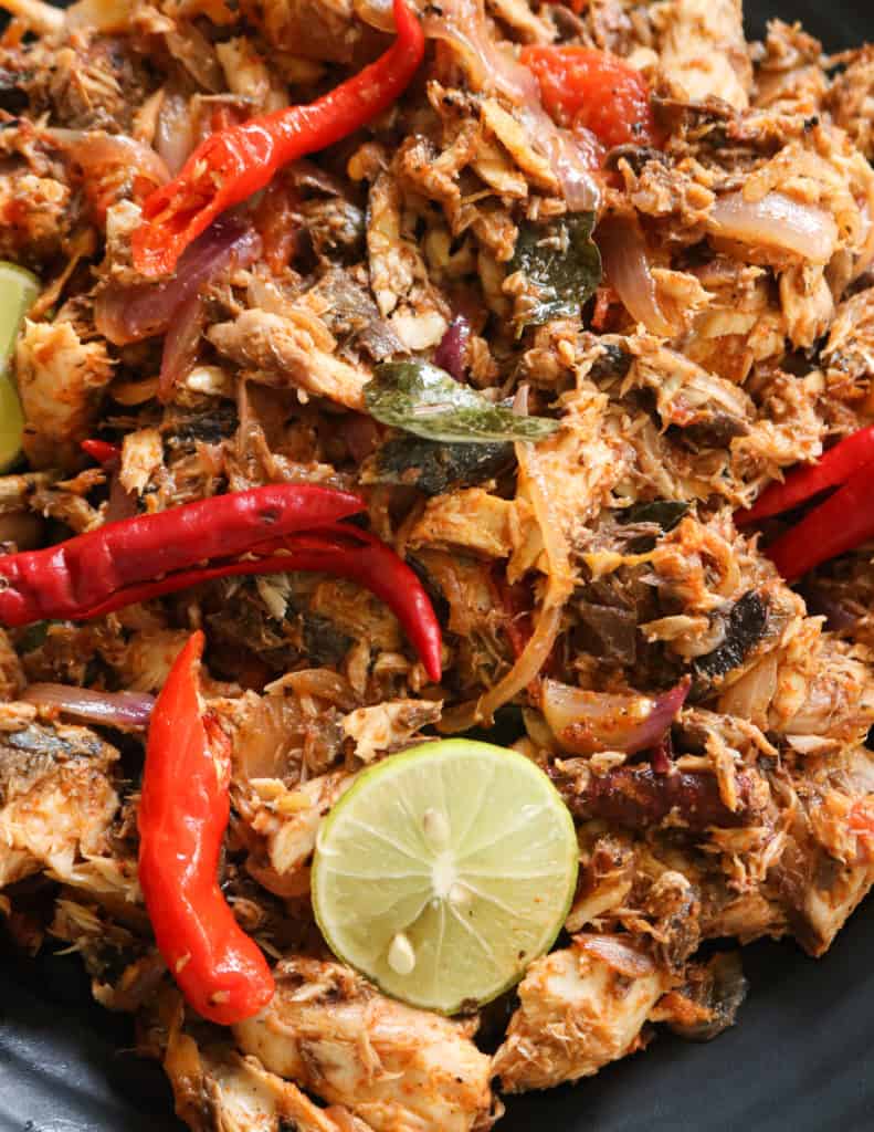 canned mackerel stir fry with slices of lime wedges and onions tempered.