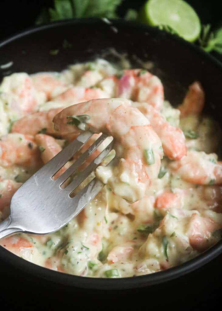 creamy shrimp salad with shrimp in a fork.