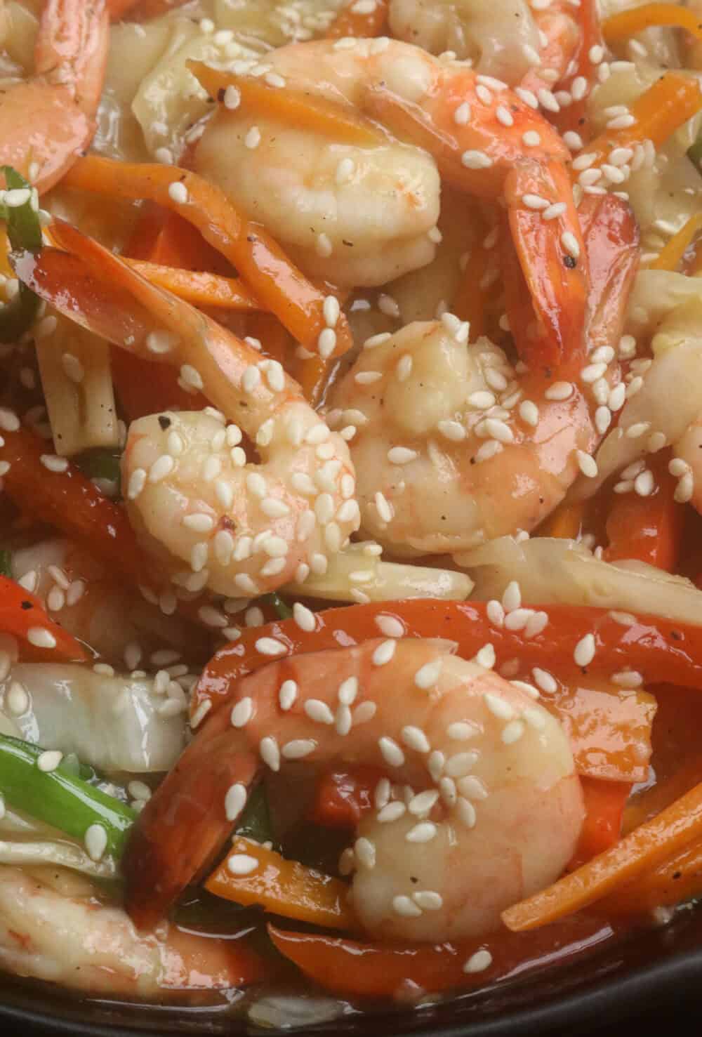 shrimp stir fry with vegetables and garnish with sesame seeds.