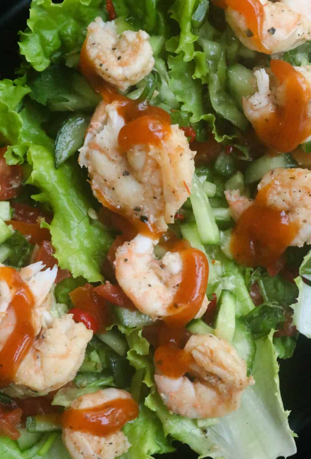 two or three lettuce full of tomatoes, cucumbers and shrimp.